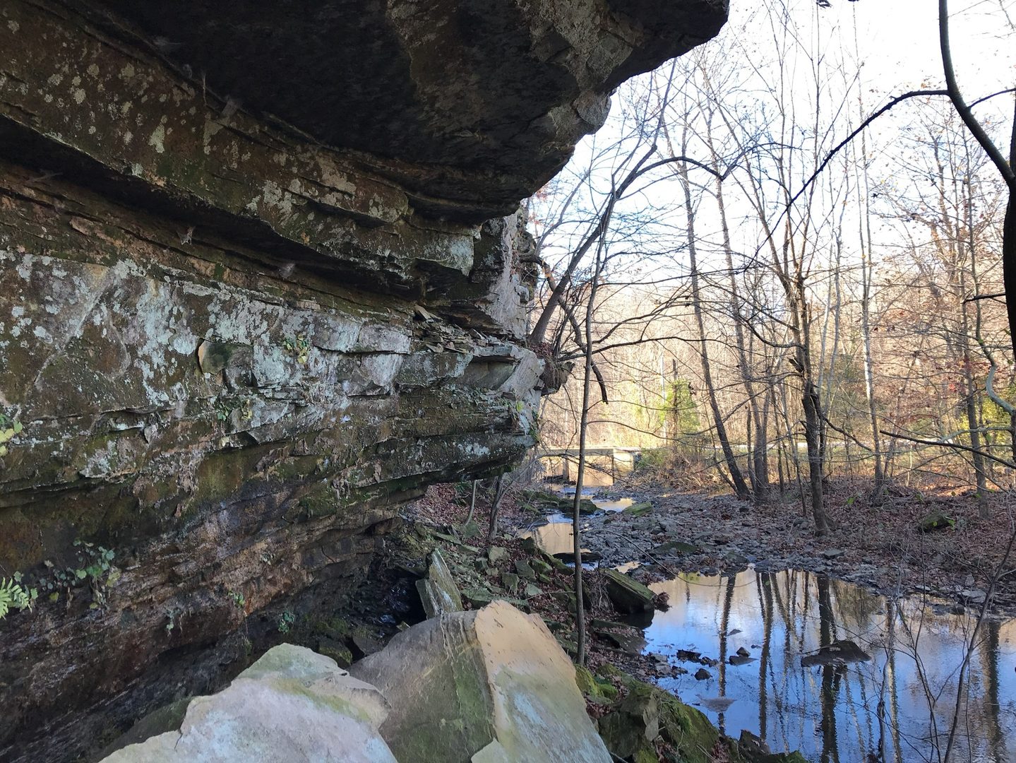 Creek flowing between limestone cliffs below the spillway